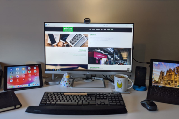 Desk with PC showing Veritau website - top tips for working from home